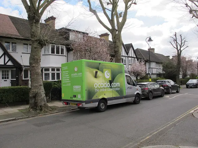 An Ocado-branded online grocery delivery van parked on a residential street in West Acton.