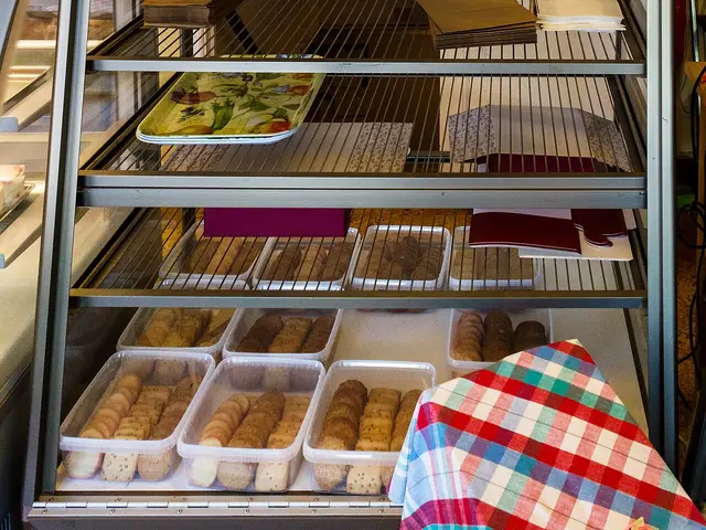 Bakery display cases with cakes and pastries.