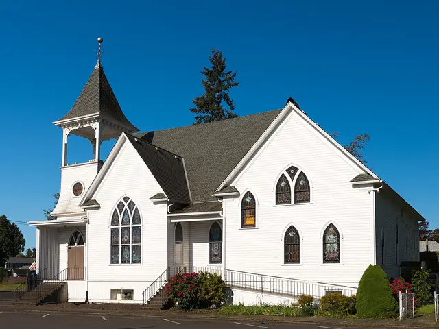 Exterior of a white wooden Evangelical Church building in Dallas, Oregon.