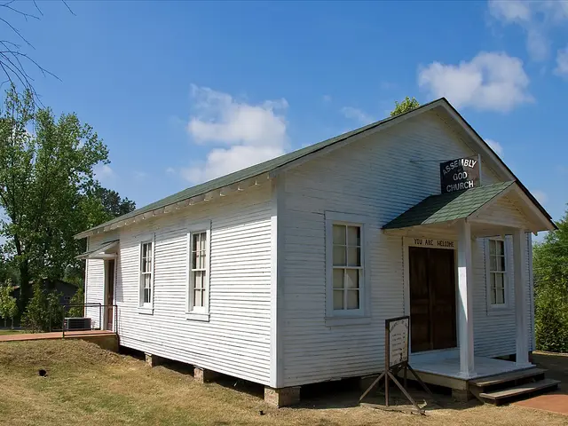 Exterior of a small white wooden Assembly of God church building in Tupelo, Mississippi.