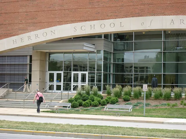 The brick entrance of Herron School of Art and Design, with its name carved into the stone above the doorway.