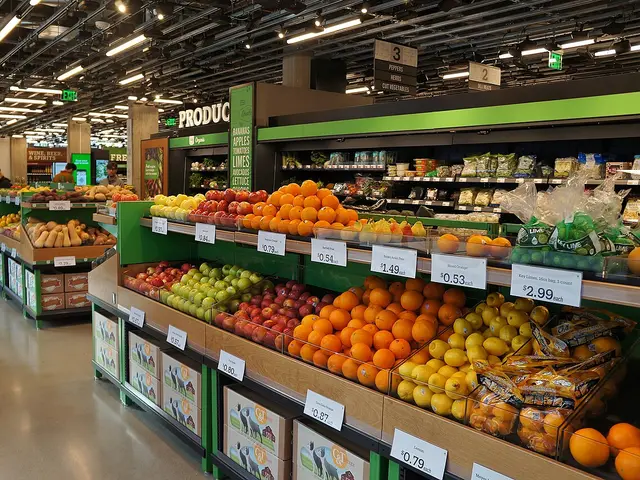 Produce section inside a grocery store in Seattle, with fruit and vegetables displayed under a plant-covered ceiling.