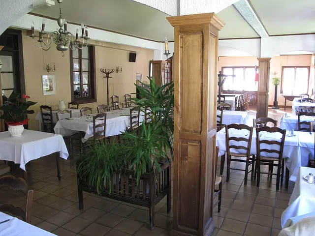 The restaurant hall of the Hotel des Touristes in Licq-Athérey, France, with tables set for dining.