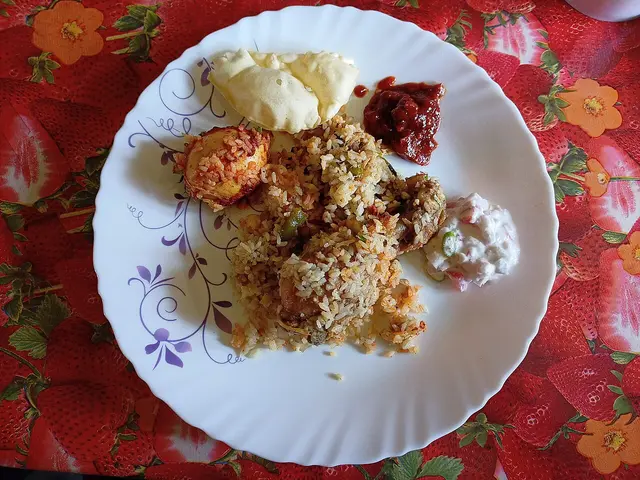 A plate of chicken biryani, a spiced Indian rice dish.