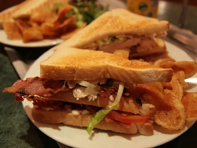 A club sandwich layered with chicken, bacon, and salad.