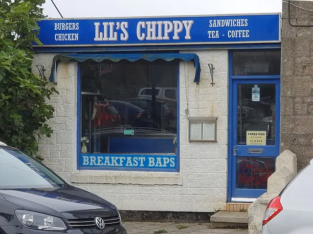 Street view of a small village chip shop storefront.