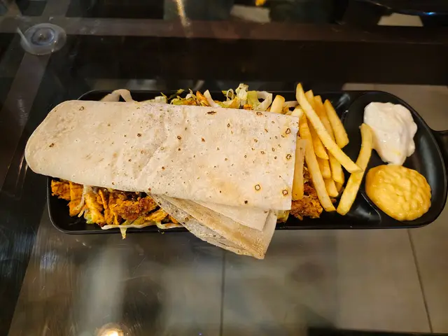 A chicken shawarma plate served with rice.