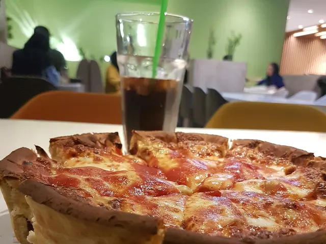A slice of Chicago-style deep-dish pizza showing its thick layered crust.