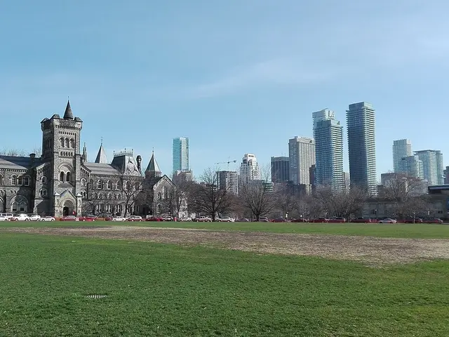 The historic stone facade of University College at the University of Toronto, seen across a lawn