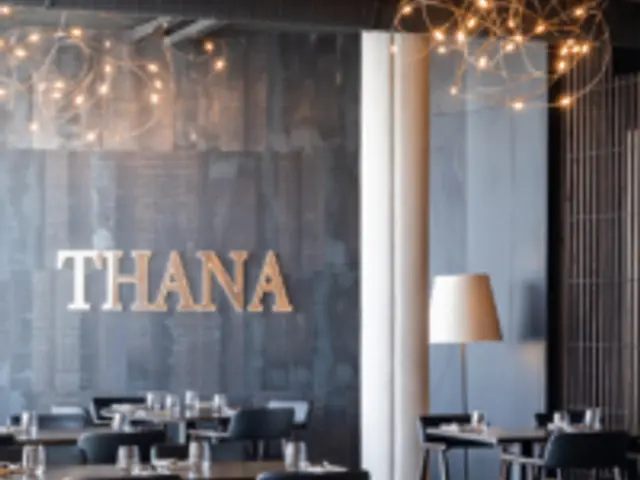 A table set for guests in the dining room of a fine dining restaurant.