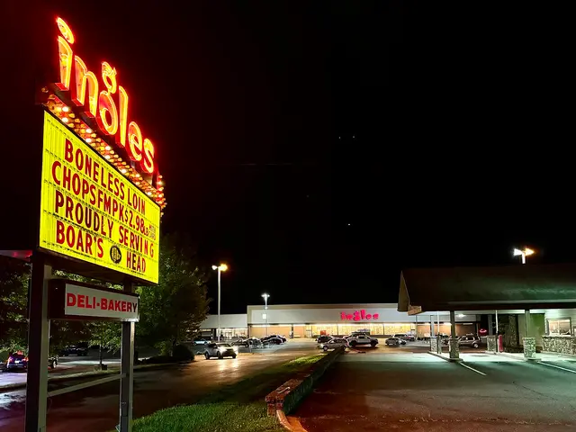 Ingles supermarket illuminated sign and storefront at night, with a deli and bakery entrance