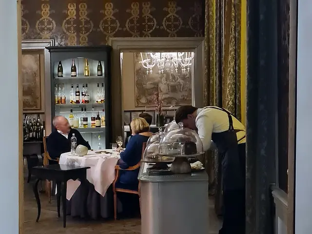 The interior dining room of a fine dining restaurant in a historic building.