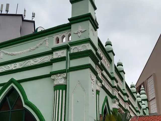 The green-painted exterior of a mosque