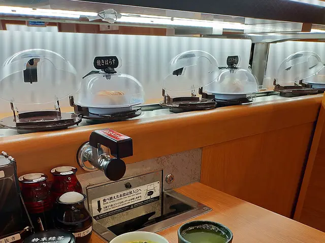 A Japanese sushi platter served with pudding and green tea.