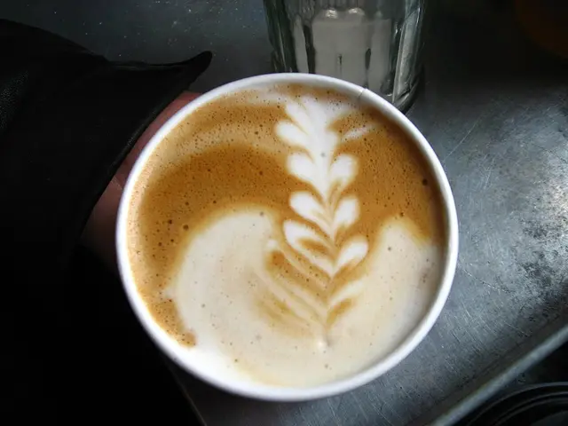 A latte with decorative art at a cafe.