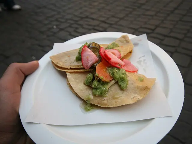 Street tacos filled with bean and potato on a plate.