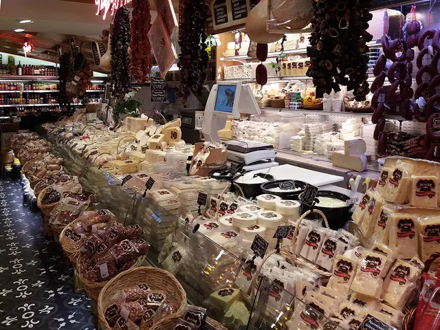A delicatessen counter piled high with cheeses, cured meats and preserved foods in an Istanbul food shop
