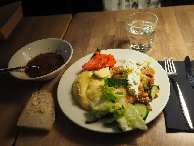 A plate of salad served as a starter at a restaurant table.