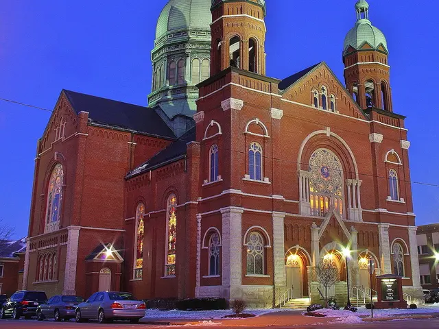 Exterior of Immaculate Conception Catholic Church in Celina, Ohio, its spire photographed at dawn.